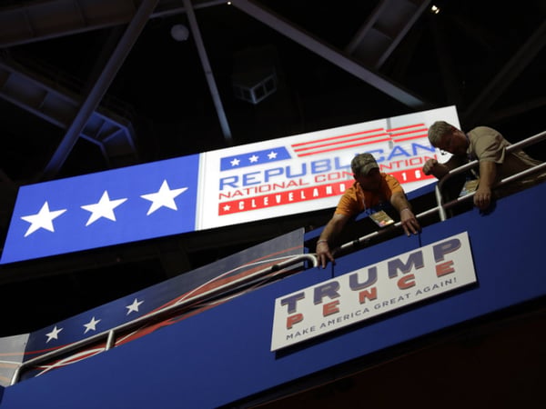 Workers place a sign as they prepare at Quicken Loans Arena for the Republican National Convention, Sunday, July 17, 2016, in Cleveland. 