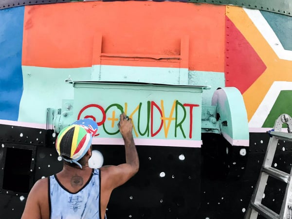 Artist Okuda San Miguel puts the finishing touches on the first complete mural of the 2017 festival.