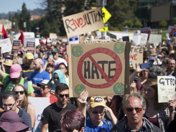 People hold up signs during a rally against hate in Berkeley, Calif., Sunday, Aug. 27, 2017.