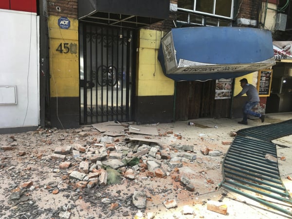 A man enters a damaged building after an earthquake in Mexico City, Tuesday, Jan. 19, 2017. A powerful earthquake has jolted Mexico, causing buildings to sway sickeningly in the capital on the anniversary of a 1985 quake that did major damage.