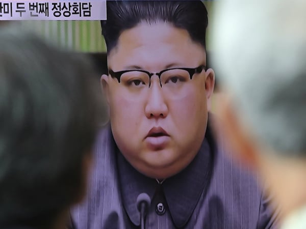 People watch a TV screen showing an image of North Korean leader Kim Jong Un delivering a statement in response to U.S. President Donald Trump's speech to the United Nations, Friday, Sept. 22, 2017.