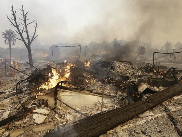 Flames rise from the remains of a house that burned down in Santa Rosa, Calif., Monday, Oct. 9, 2017. 
