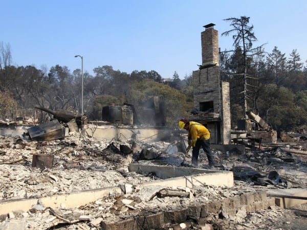 Berkeley firefighter Matt George picks through the ash of a Santa Rosa neighborhood looking for smoldering materials Oct. 12, 2017. "It's unbelievable, the destruction," he says.