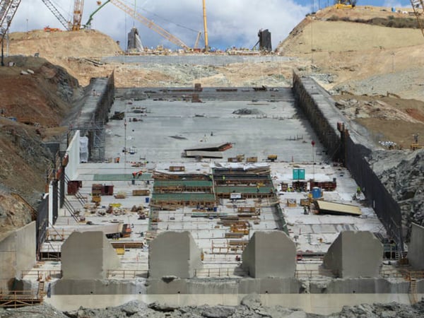 Crews set up concrete pours in a checkerboard pattern at Lake Oroville. Workers must wait four days for concrete to cure before pouring adjacent concrete. Millions of cubic feet of concrete will be poured before the project is completed.