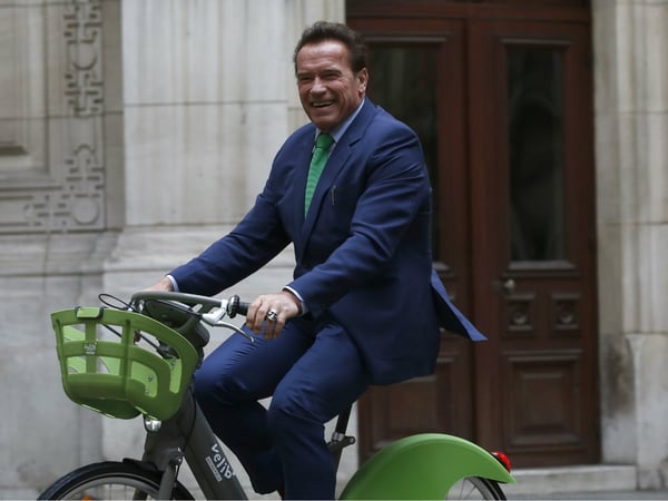 Arnold Schwarzenegger arrives on bicycle to meet Paris mayor Anne Hidalgo, Monday Dec. 11, 2017 in Paris. Schwarzenegger is in Paris to attend the One Planet climate summit Tuesday.