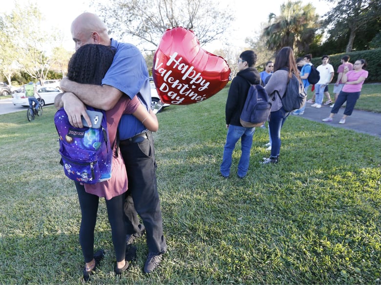Family member embrace following a shooting at Marjory Stoneman Douglas High School, Wednesday, Feb. 14, 2018, in Parkland, Fla. 