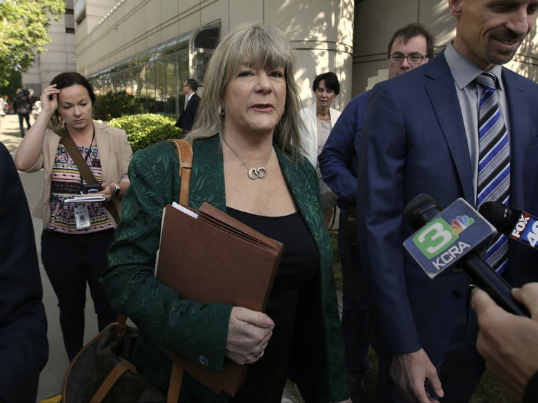 Diane Howard, the public defender for alleged serial killer Joseph James DeAngelo, is surrounded by reporters after a court appearance in Sacramento County Superior Court, Thursday, May 3, 2018, in Sacramento, Calif.