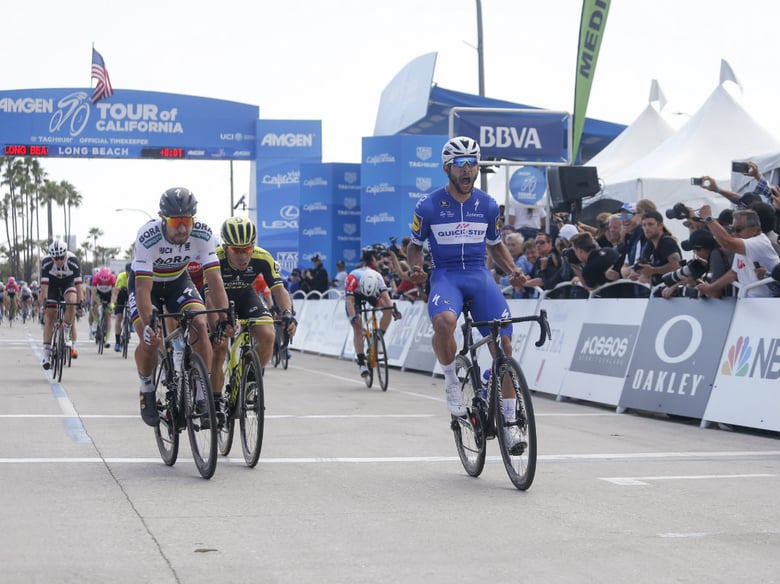 Fernando Gaviria, front, of Colombia, celebrates after crossing the finish line to win the first stage of the Amgen Tour of California cycling race, Sunday, May 13, 2018, in Long Beach, Calif. 