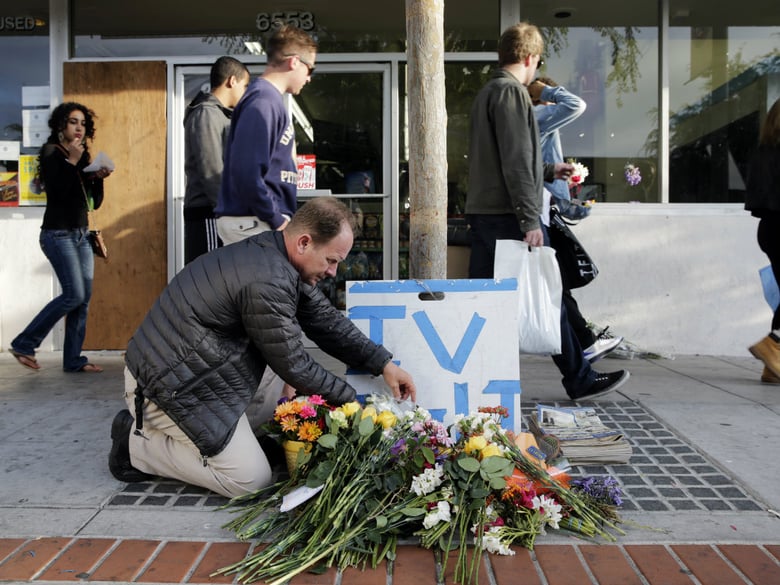In this May 24, 2014 file photo, Stephen Nichols arranges flowers left where part of a mass shooting took place by Elliot Rodger in Isla Vista, Calif. Rodger has become a symbol for an online community of young male supremacists called 'incels'.
