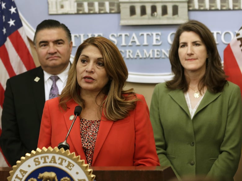Assemblywoman Sharon Quirk-Silva-D-Fullerton, center, discusses her proposed state constitutional amendment that would curb the University of California's autonomy during a news conference, Tuesday, May 22, 2018, in Sacramento.