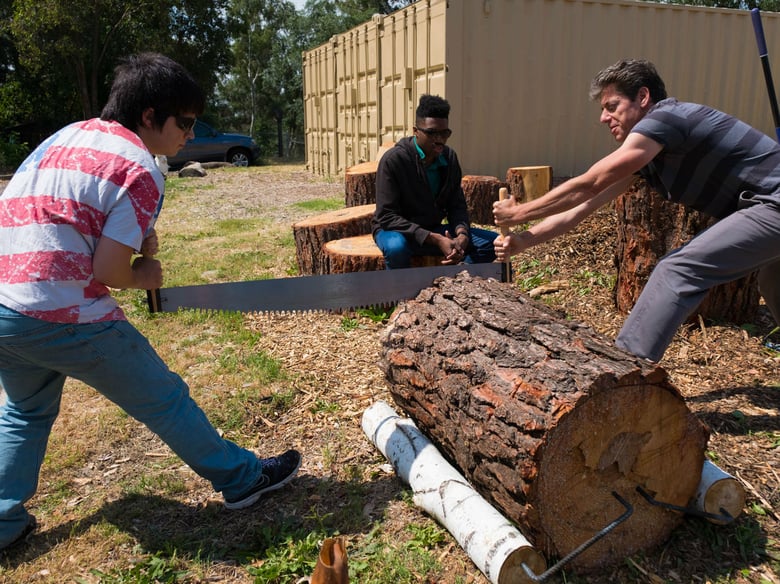 Meristem instructor Justin Ganz, right,  helps students in a woodworking class.