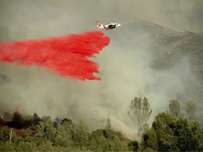An air tanker drops retardant on a wildfire burning above the Spring Lakes community on Sunday, June 24, 2018, near Clearlake Oaks, Calif.