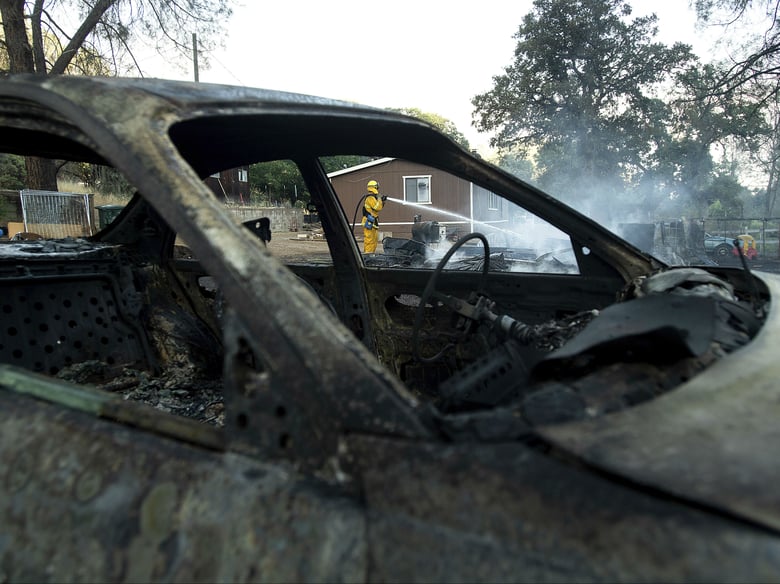 Firefighter Richard Cotter battles a wildfire on Sunday, June 24, 2018, near Clearlake Oaks, Calif. Wind-driven wildfires destroyed buildings and threatened hundreds of others Sunday as they raced across dry brush in rural Northern California.
