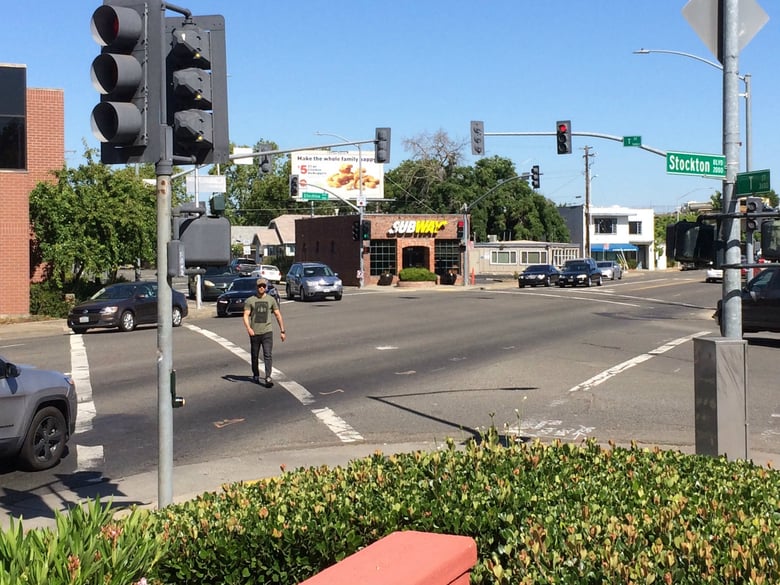 Sergio Arriaga crosses Stockton Boulevard at T Street. The city of Sacramento plans to improve a portion of Stockton Boulevard to increase safety for cyclists and pedestrians. 