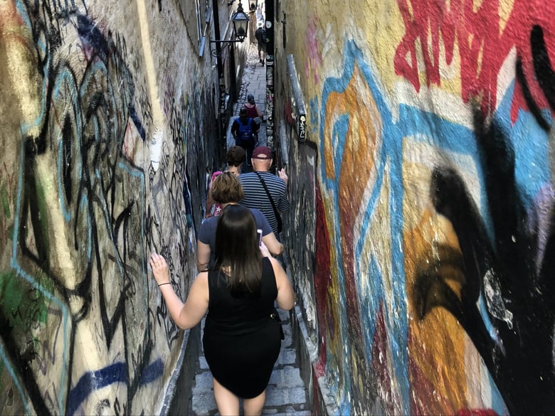 CapRadio travelers walk down the narrowest street in Stockholm's old city. 