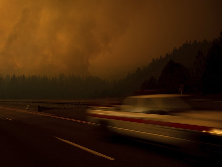 A fire vehicle drives along Interstate 5 as the Delta Fire burns in the Shasta-Trinity National Forest, Calif., on Thursday, Sept. 6, 2018.