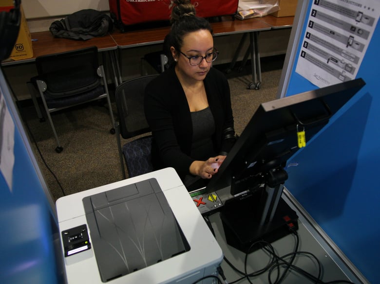 Jasmine Cardenas votes via touchscreen at the Sacramento County administrative center on Nov. 6, 2018.