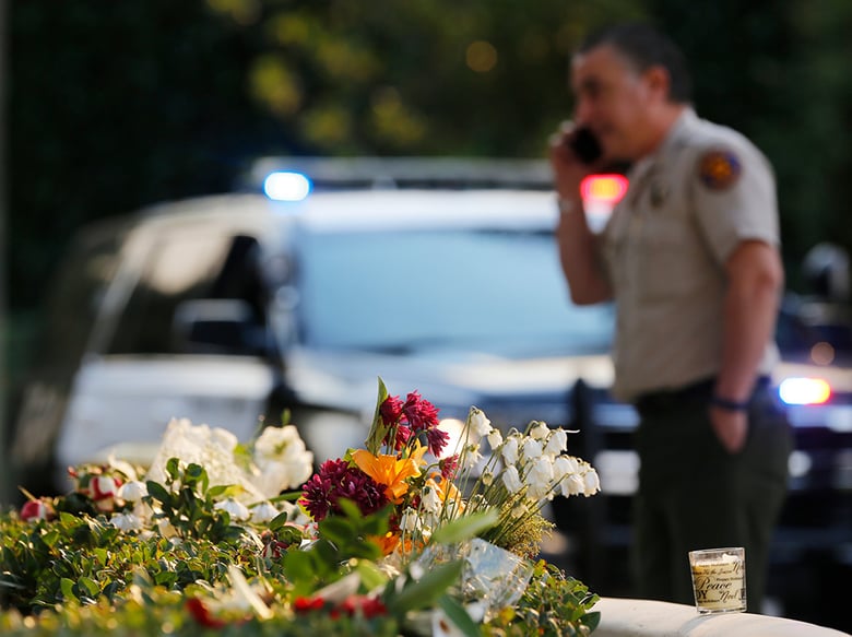 A bouquet of flowers, left by mourners, lays near the site of Wednesday's mass shooting, in Thousand Oaks, Calif., Friday, Nov. 9, 2018.