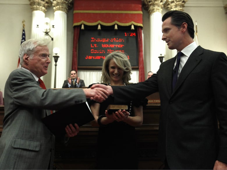 In this Jan. 10, 2011, file photo, Gavin Newsom, right, shakes hands with his father, William Newsom, a former Associated Justice of the California Court of Appeals.