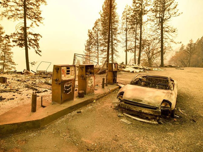A burned car and a gas station remain visible after the Camp Fire tore through the region near Pulga, east of Paradise, California, on Nov. 11, 2018.