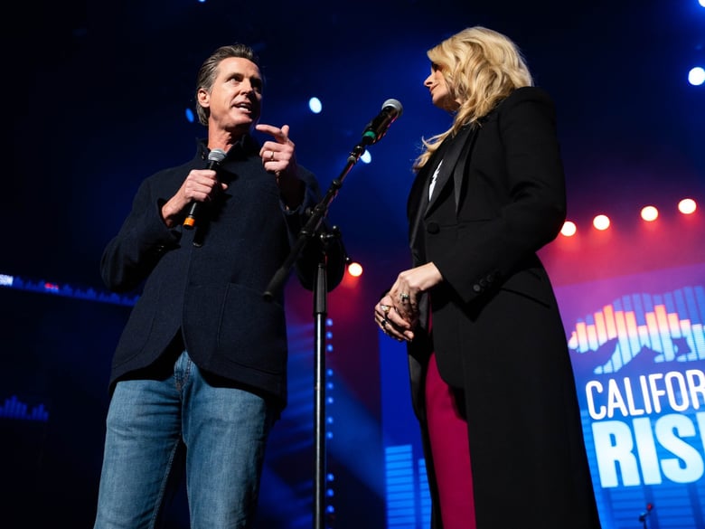 Governor-elect Gavin Newsom and his wife, Jennifer Siebel Newsom, address the audience at the "California Rises" benefit concert at Golden 1 Center in Sacramento on Jan 6, 2019.