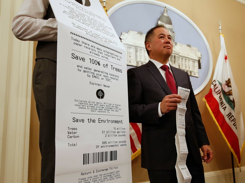 Assemblyman Phil Ting, D-San Francisco, displays a long paper receipt as he discusses his bill to require businesses to offer electronic receipts, Tuesday, Jan. 8, 2019, in Sacramento, Calif.