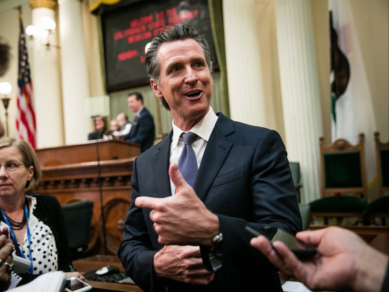Gov. Gavin Newsom speaks to reporters on the floor of the Assembly chambers on December 3, 2018 at the State Capitol in Sacramento, California.