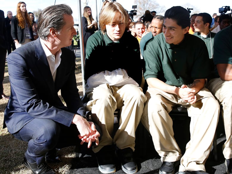 Gov. Gavin Newsom talks with Juan Cruz Lopez Jr. right, a youthful offender at the O.H. Close Youth Correctional Facility, Tuesday, Jan. 22, 2019, in Stockton, Calif.