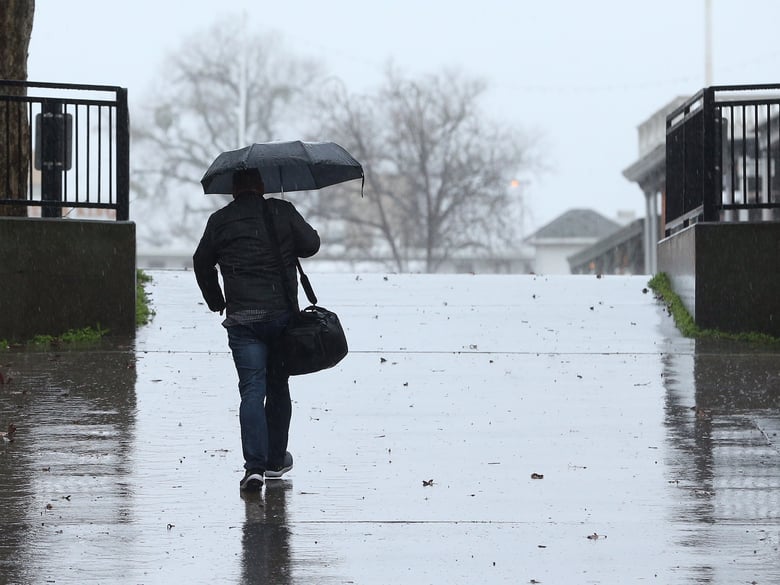 Umbrellas were put to use as a storm moved through Sacramento, Calif., Wednesday, Feb. 13, 2019.