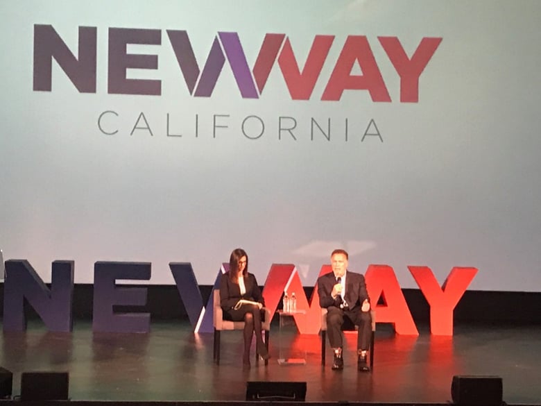 Arnold Schwarzenegger on stage speaking with Stanislaus County Supervisor Kristin Olsen at the New Way California 2019 Summit.