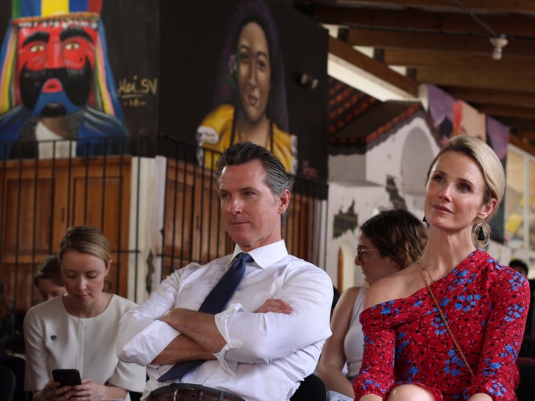 California Gov. Gavin Newsom and his wife, Jennifer Siebel Newsom, right, listen to a recital of violins by young Salvadorans who belong to a music academy in Panchimalco, El Salvador, Monday, April 8, 2019.