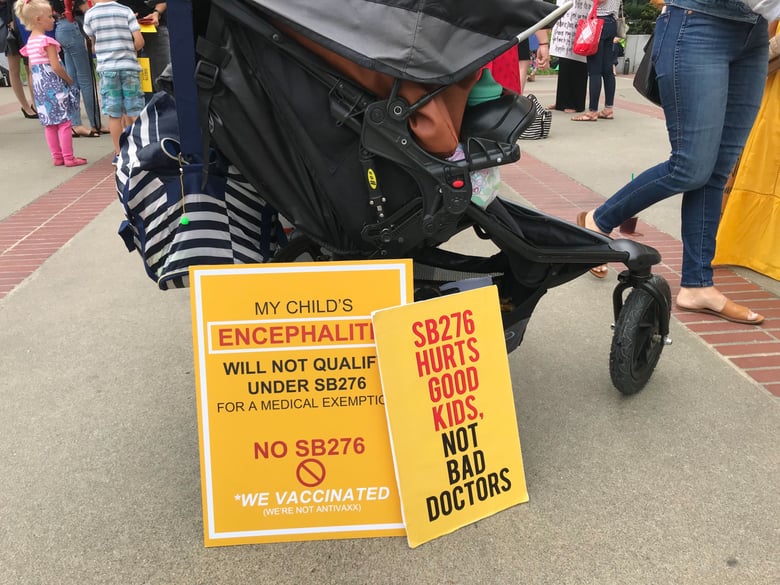 Families protest vaccine bill SB 276 outside the state Capitol.