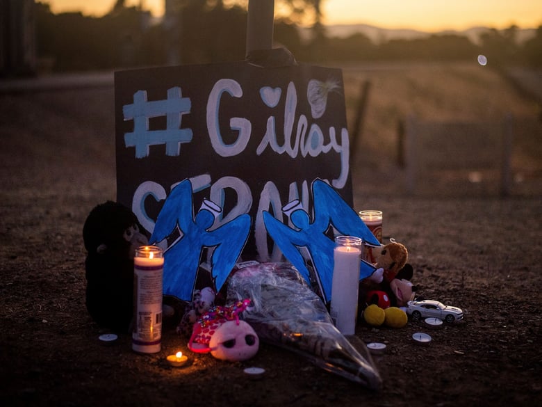 Candles burn at a makeshift memorial for Gilroy Garlic Festival shooting victims outside the festival grounds, Monday, July 29, 2019, in Gilroy, Calif.