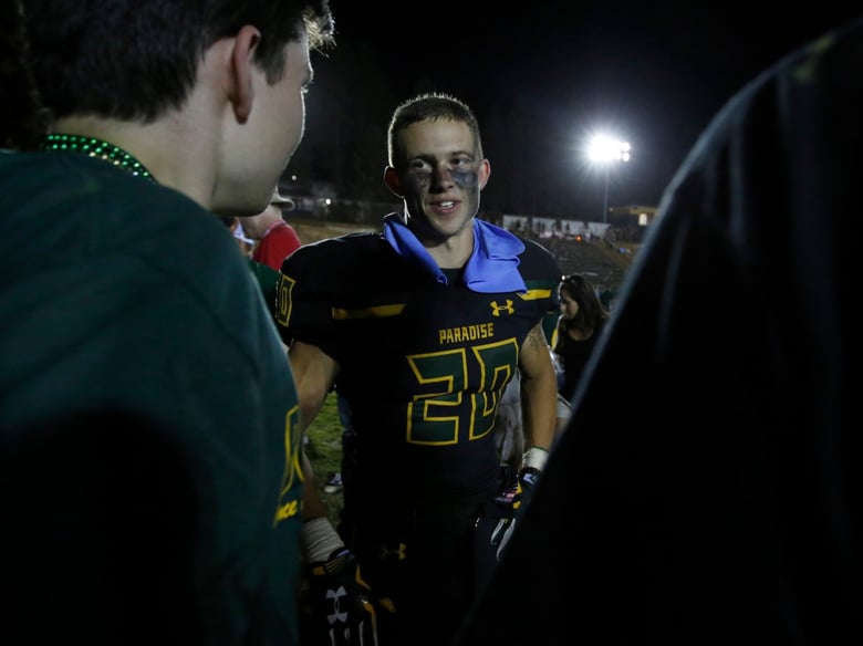 Paradise High School running back Lukas Hartley, center, talks with friends after defeating Williams High School 42-0 in Paradise, Calif.