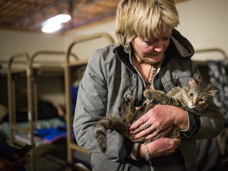 Julie Hemingway cuddles her pet tabby cat, Tammy, at the Sacramento Triage Shelter for people who are homeless in Sacramento.