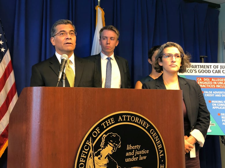 California Attorney General Xavier Becerra, left, speaks at a news conference, Monday, Sept. 23, 2019, in Sacramento, Calif., announcing a lawsuit against an auto dealer.