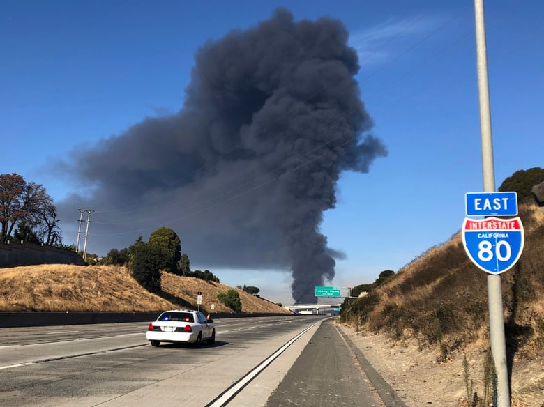 Interstate 80 is closed as a fire at an oil storage facility burns in the background Tuesday, Oct. 15, 2019, in Rodeo, Calif.