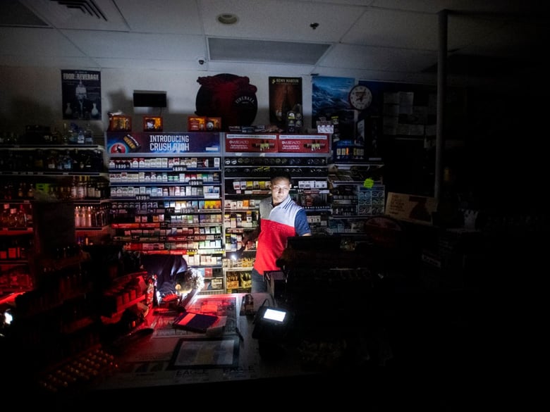 Sodhi Singh, closes up his Chevron station shortly after losing power in Healdsburg, Calif., on Saturday, Oct. 26, 2019.