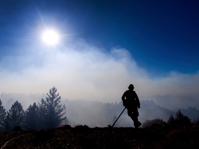 Firefighter Josh Petrell monitors the Kincade Fire burning near Healdsburg, Calif., on Tuesday, Oct. 29, 2019. The overall weather picture in northern areas is improving as powerful, dry winds bring extreme fire weather to Southern California.