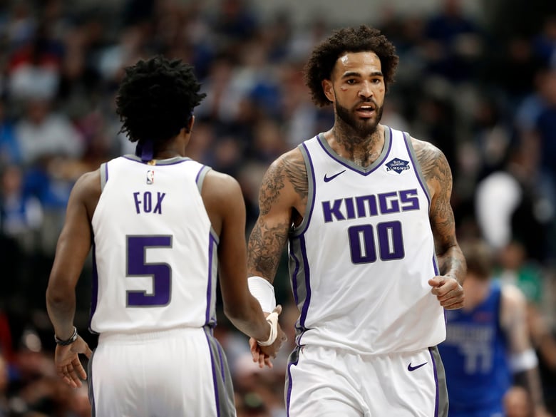 Sacramento Kings' Willie Cauley-Stein and De'Aaron Fox celebrate a basket against the Dallas Mavericks during the first half of an NBA basketball game in Dallas, Tuesday, March 26, 2019.