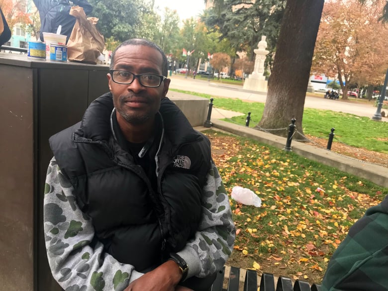 Jason Richburg sits in Cesar Chavez Plaza in downtown Sacramento on Dec. 5, 2018. He says it can be tough for homeless people to get to Loaves and Fishes and other resource centers for supplies, so hand-outs from strangers are key to surviving.