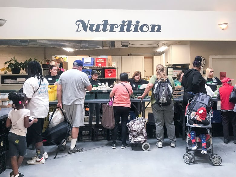 People pick up produce, canned goods, meat, dairy and bread at the River City Food Bank in Sacramento.