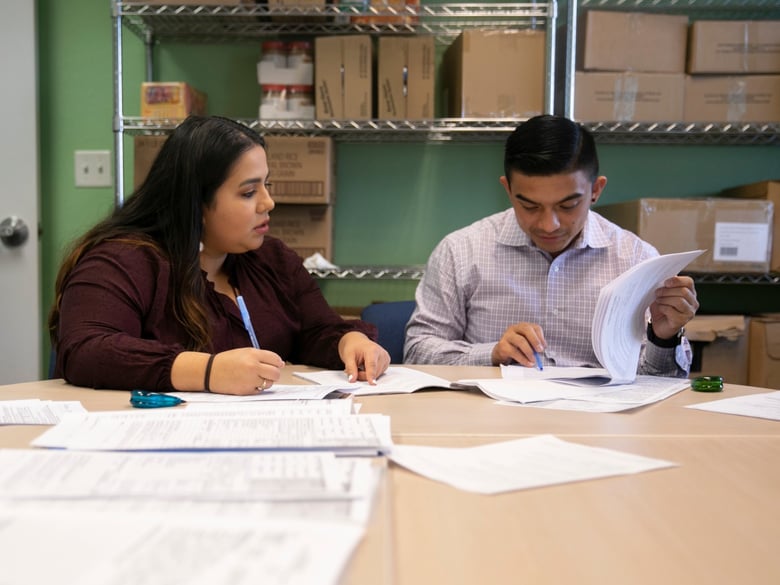 Volunteer Daniella Martinez, left, and Shane Sagisi, a law clerk with San Mateo County Legal Aid, fill out unlawful detainer forms during a housing clinic at the Colma Civic Center.