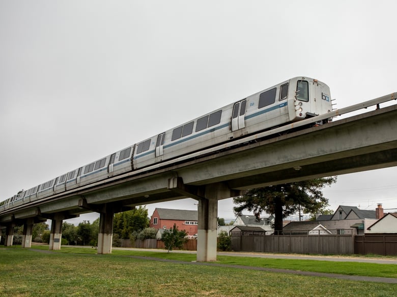 A BART train runs through a neighborhood of single-family homes in Albany. California lawmakers again rejected a bill that would have led to denser development along public transit routes.