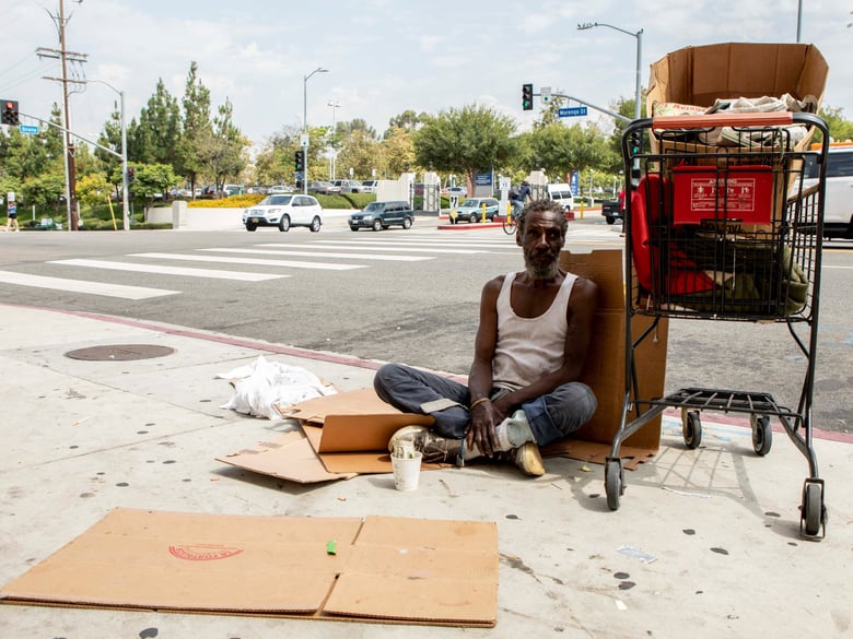 Will, a homeless man who provided his first name only, sits on a sidewalk in Los Angeles.