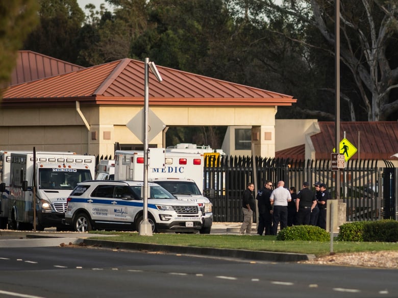 A group of ambulances from the Solano EMS Cooperative stage at the visitor center at Travis Air Force Base, adjacent to Fairfield, Calif., Sunday, Feb. 16, 2020.
