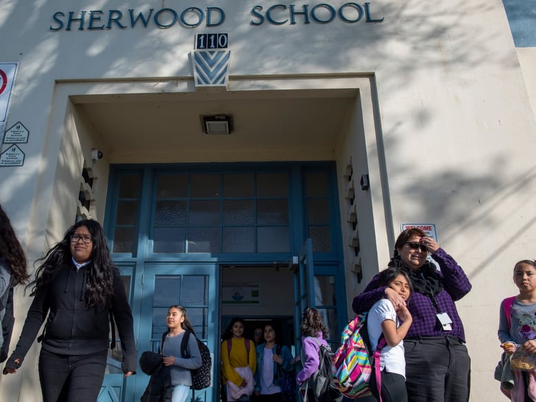 Maria Castellanoz has been teaching at Sherwood Elementary School for 22 years. Castellanoz hugs a student as she watches other students get picked by their parents.