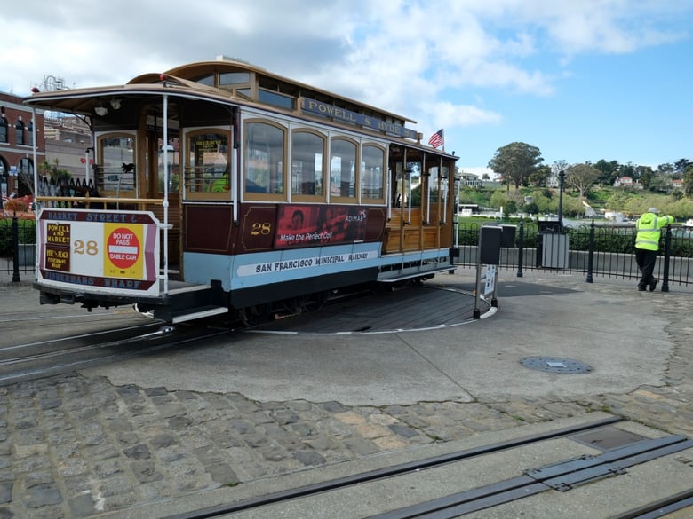 A cable car operator looks out toward the Golden Gate Bridge while standing at the near-empty Hyde Street turnaround Monday, March 16, 2020, in San Francisco.