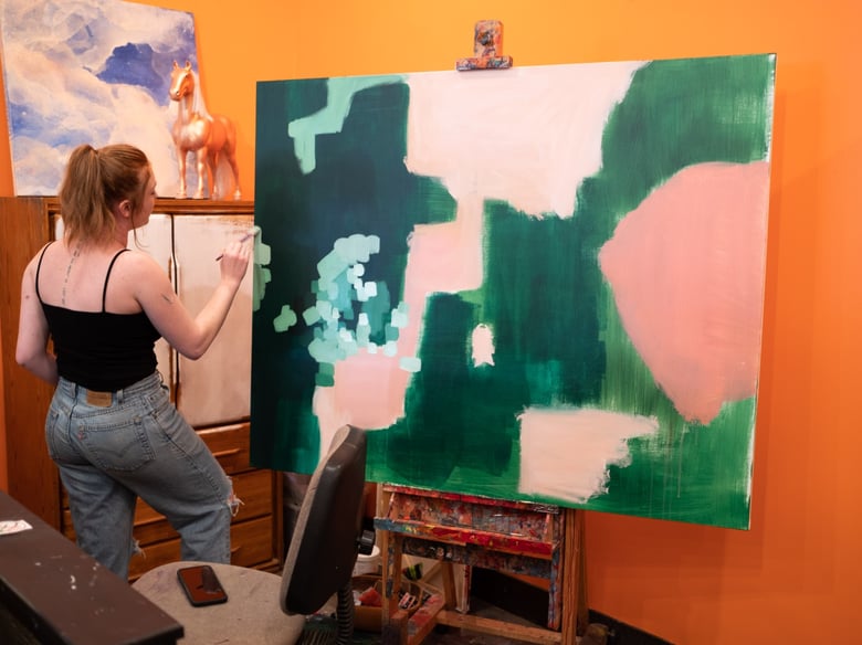 Hadyn George paints a canvas in her store on Vernon Street in Roseville, Calif. on Thursday March 5, 2020.