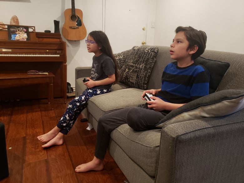 Melina, 8, and her brother Adrian, 9, play minecraft before bed. With limited classwork provided by their district the Torres kids have plenty of time for video games when their homework is finished.